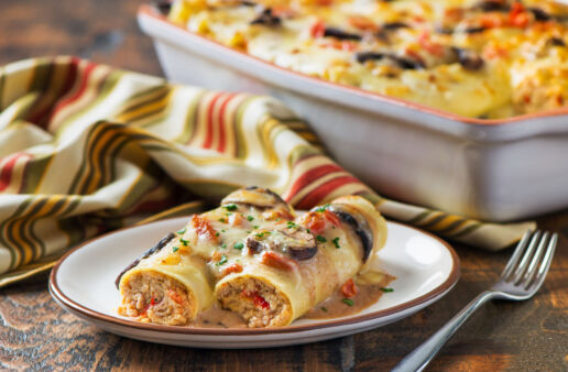 chicken-and-proscuitto-cannelloni-with-mushroom-and-alfredo-sauce-served-on-a-plate