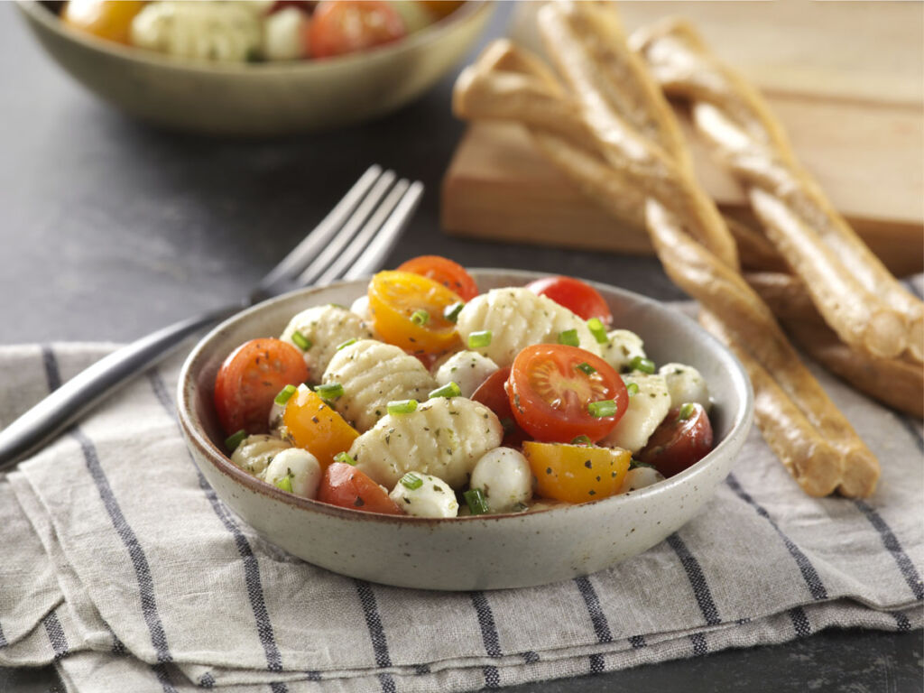 cold-gnocchi-pasta-salad-with-tomatoes-mixed-in-a-bowl