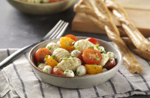 cold-gnocchi-pasta-salad-with-tomatoes-mixed-in-a-bowl